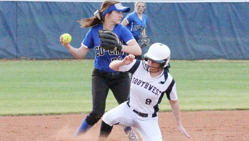 Co-Lin Media / Natalie Davis / Co-Lin second baseman Kamryn Vanlandingham turns to throw to first for the double play avoiding the slide from Kelcey Bremenkamp (9) in Monday's softball action at Summit.