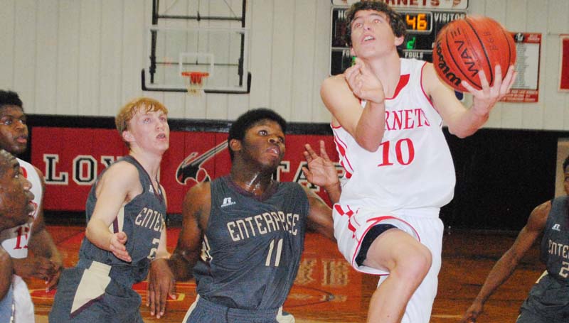 Daily Leader / Marty Albright / Loyd Star's Cade Hodges (10) drives in for a layup against Enterprise in boys' action Tuesday night at Loyd Star Gymnasium.