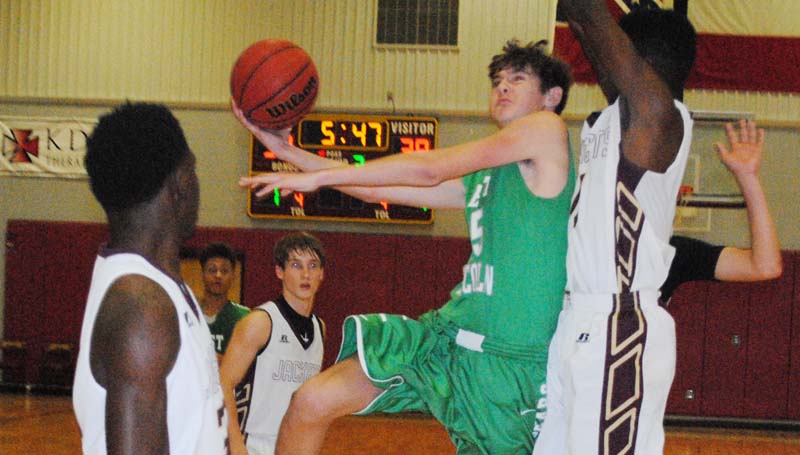 Daily Leader / Marty Albright / West Lincoln's Adam Martinez (15) shoots a tough shot over Enterprise's Dwayne Pendleton (23) and Jontavious Smith (35) in boys action Friday night.