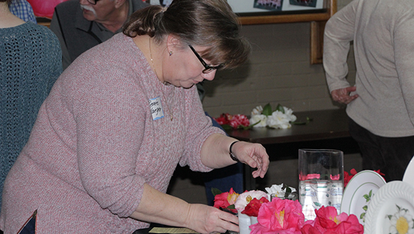 Photo by Alex Jacks / Renée Yaeger judges bloom entries during the 53rd annual Camellia Show held at the Brookhaven Recreation Department Saturday. Entries came from all over the country including Florida and Louisiana.