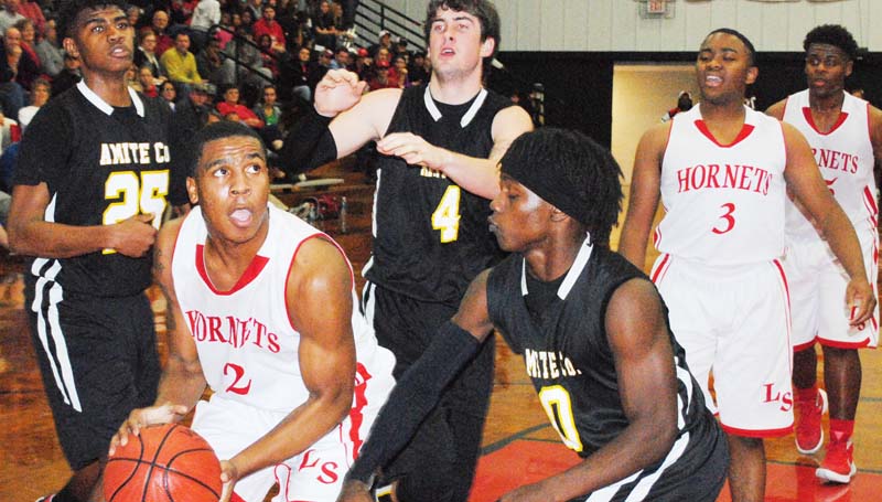 Daily Leader / Marty Albright / Loyd Star's Javion Bears (2) powers in the paint to score a basket against Amite County Tuesday night in boys' action.