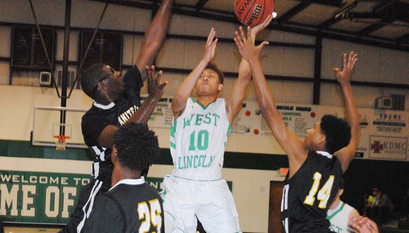 Daily Leader / Marty Albright / West Lincoln's Ronnie Edwards (10) shoots a tough shot in between three Amite County defenders Tuesday night.