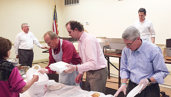 Photo by Scott Kimbrell Jr. / Brookhaven Servitium Club members serve pancakes and sausage at the 65th annual Tom Moak Memorial Pancake and Sausage Day Tuesday. The event, which took place at the State Room at State Bank, serves as a fundraiser for the club. Proceeds will go toward youth-related programs in the community.