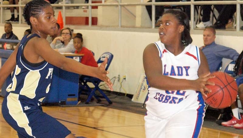 Daily Leader / Tracy Fischer / Wesson's Alaysha Mims (22) looks to make a pass while Franklin County's defender Shemiah Amos (25) apply pressure in girls action Wednesday.