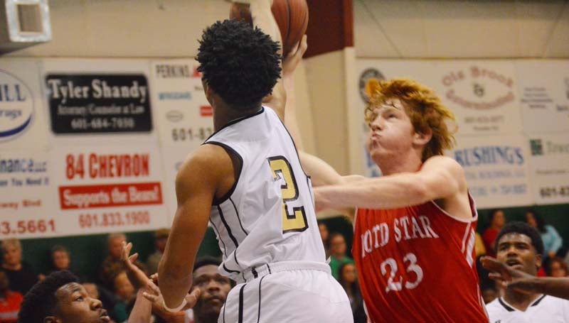 Daily Leader / Chris King / Loyd Star's Levi Redd (23) drives in for a tough shot as Bassfield's Mason Sims (2) tries to block the attempt Friday night in boys' consolation action at West Lincoln.