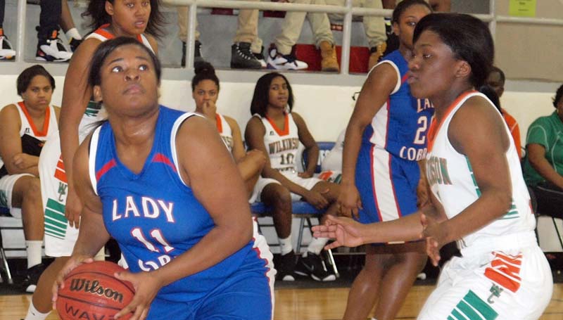 Daily Leader / Tracy Fischer / Wesson's Carnesha Green (11) looks to score a basket over Wilkinson County's Erielle Jackson (12) in girls' Region 7-3A consolation game at the Snake Pitt.