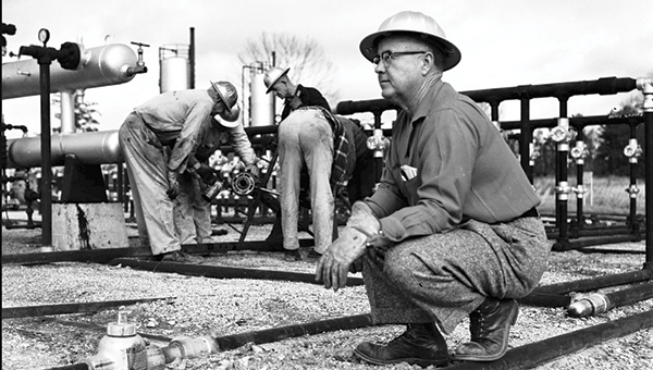 Photo courtesy of the Lincoln County Public Library / Bennie London poses for Roland School United Press News Pictures in Lincoln County in February 1956. Oil has always been an important industry to Lincoln County.