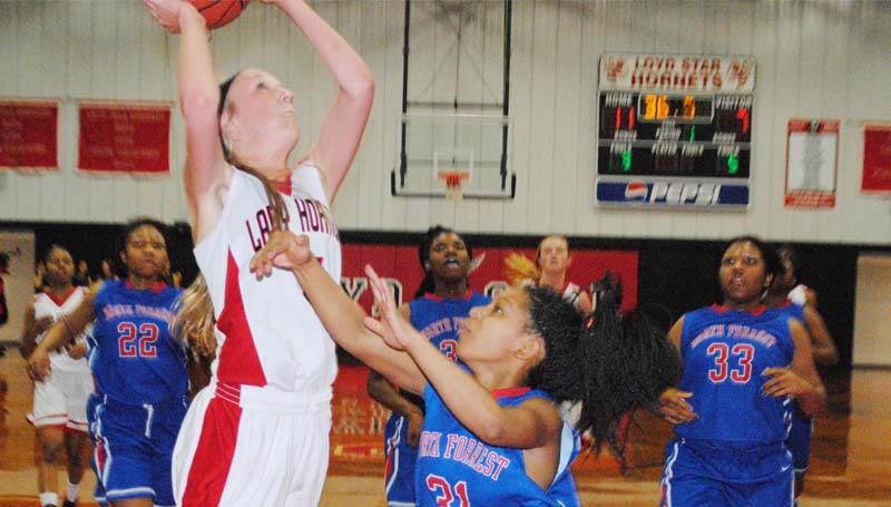 Daily Leader / Marty Albright / Loyd Star's McKenzie Smith (5) scores an easy basket Monday night and was fouled by North Forrest's MohGnwy McNaulty (21) on the play in Class 2A girls state playoff action.