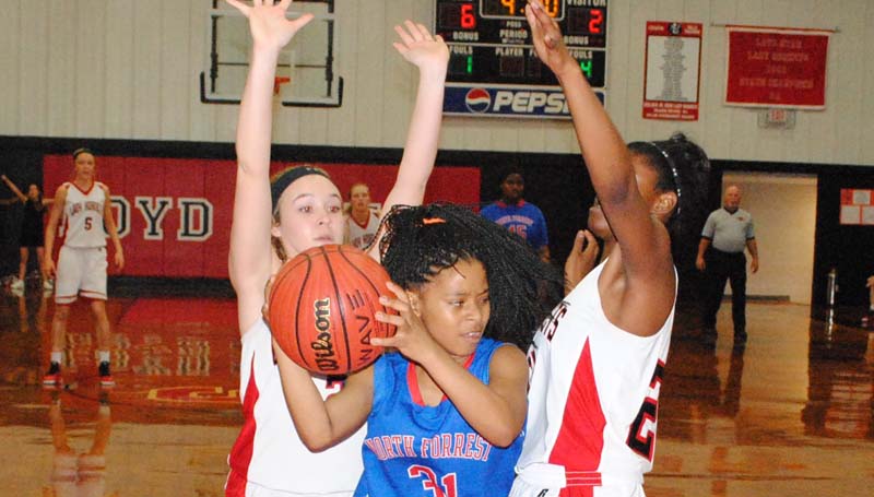 Daily Leader / Marty Albright / Loyd Star's Lydia Britt (2) and Jordan Shelby (22) apply defensive pressure on North Forrest's Mohaganey McNaulty (31) in the back court Monday night.