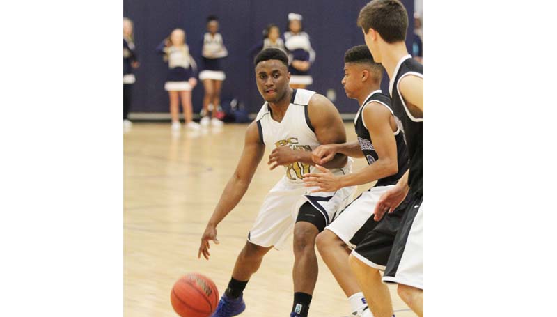 Daily Leader / Amy Rhoads / Bogue Chitto's Rudy Brumfield (10) looks to drive past two Sacred Heart defenders in Wednesday night boys' state playoff action.