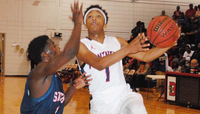 Daily Leader / Marty Albright / Brookhaven Danarius Gray (1) drives in to score a layup over a South Jones defender in Wednesday night boys' action at Sinclair Gymnasium.