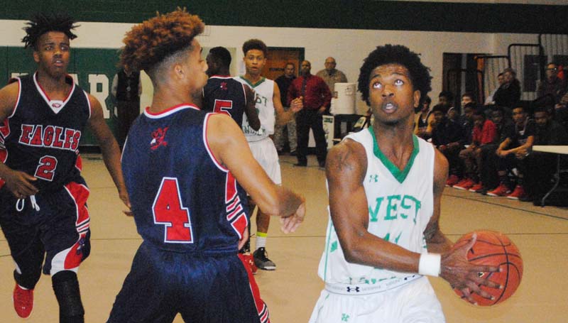 Daily Leader / Marty Albright / West Lincoln's Keshaun London (11) scores two of his 28 points against East Marion Wednesday night at Jack Case Gymnasium.