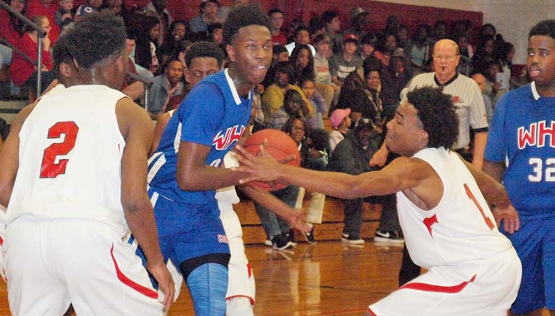 Daily Leader / Tracy Fischer / Wesson's Anthony Jones (0) is double teamed by West Marion's Adrian Miller (1) and Anthonee Mark (2) while driving to the basket Thursday night in boys' Class 3A state playoff action.