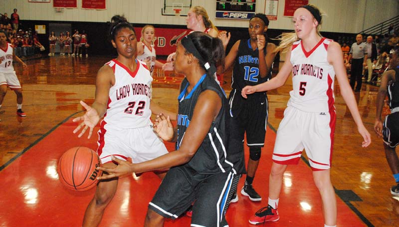Daily Leader / Marty Albright / Loyd Star's Jordan Shelby (22) and McKenzie Smith (5) team up to apply defensive pressure on Newton's Myja McNichols (34) under the basket Friday night in girls' Class 2A state playoff action.