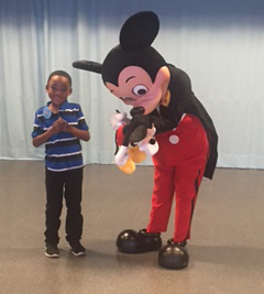 Photo submitted / Dominick Fields gets his stuffed Mickey Mouse signed by the mouse himself during his recent trip to Walt Disney World. Make-A-Wish provided the trip for Fields, who suffers from sickle cell anemia, and his family recently.