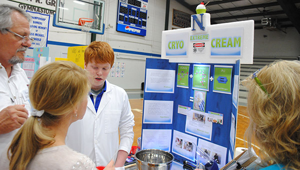 McLaine Boyd, right, stands with his science project Monday following his first place win in the seventh-eighth grade biochemistry division of Brookhaven Academy’s science fair. Boyd’s project was to use nitrogen to make ice cream. Boyd, along with 76 other first and second place winners from BA, will advance to the Mississippi Association of Independent Schools District 4 West Science Fair on March 23.