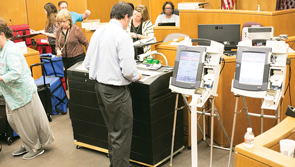 Photo by Kaitlin Mullins / Dustin Bairfield runs the machine to count the ballots cast Tuesday night.