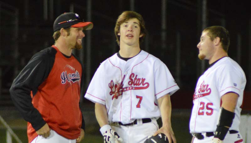 Daily Leader / Chris King / Loyd Star coach Jared Britt (left) gives instructions to juniors Parker Flowers (7) and Bradyn Brister (25) during a pitching change for Terry.
