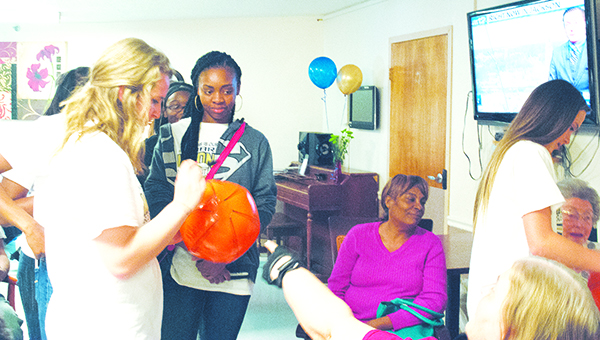 Photo by Aaron Paden / The Bogue Chitto Lady Cats basketball team visited Countrybrook Living Center Monday to celebrate its recent state championship. The team signed balls for residents and gathered for a group photo. The team is scheduled to visit the state Legislature Wednesday.