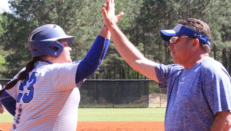 Co-Lin Media / Natalie Davis / Co-Lin catcher Jessica Crum gets a high-five from Lady Wolves head coach Allen Kent after hitting her nation leading 17th home run of the season.