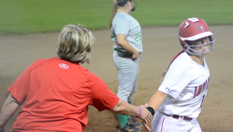 Daily Leader / Marty Albright  / Loyd Star's Megan Norton is congratulated along the third base line by head coach Jan Delaughter after hitting a solo homerun in the fifth inning against West Lincoln.