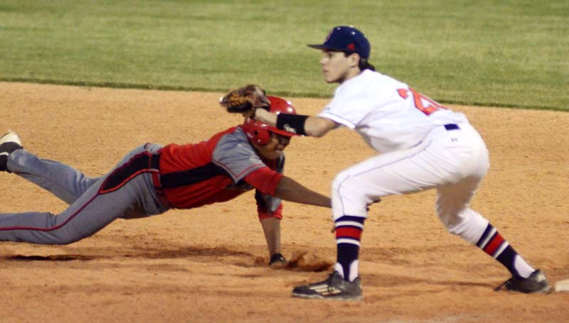 Daily Leader / Marty Albright / Brookhaven first baseman Reese Reynaud prepares to make a tag on Provine's Brandon Taylor diving back to first in Game Two at Moyer Field.