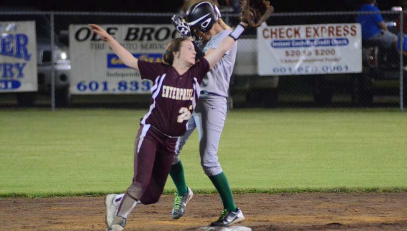 Daily Leader / Marty Albright / Enterprise's second baseman Kaylie Burgess stretch for the wild throw while West Lincoln's runner Millane Lewis reaches safely Tuesday night.