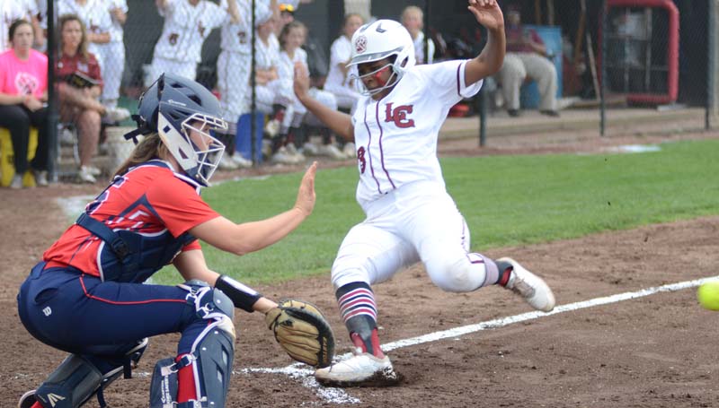 Daily Leader / Marty Albright / Lawrence County's Zyon Feazell slides into home safely as Richton's catcher Hannah Adcock prepares to make the play Thursday night.