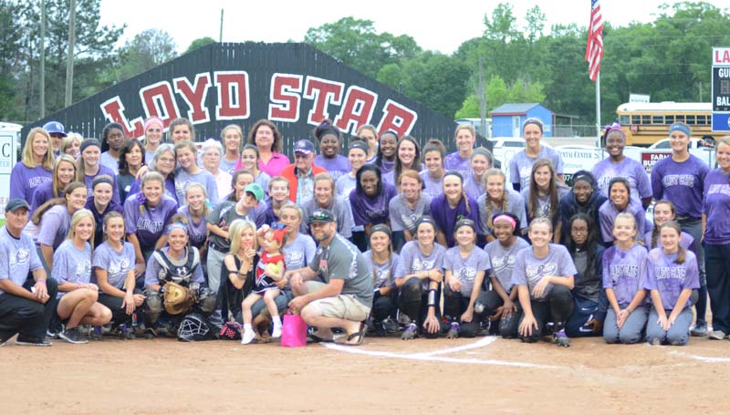 Daily Leader / Marty Albright / The Loyd Star Lady Hornets and the Bogue Chitto Lady Cats pose together with the cancer survivors Tuesday night in the second annual 'Strike Out Cancer' softball contest at the Jan Smith Delaughter Field.