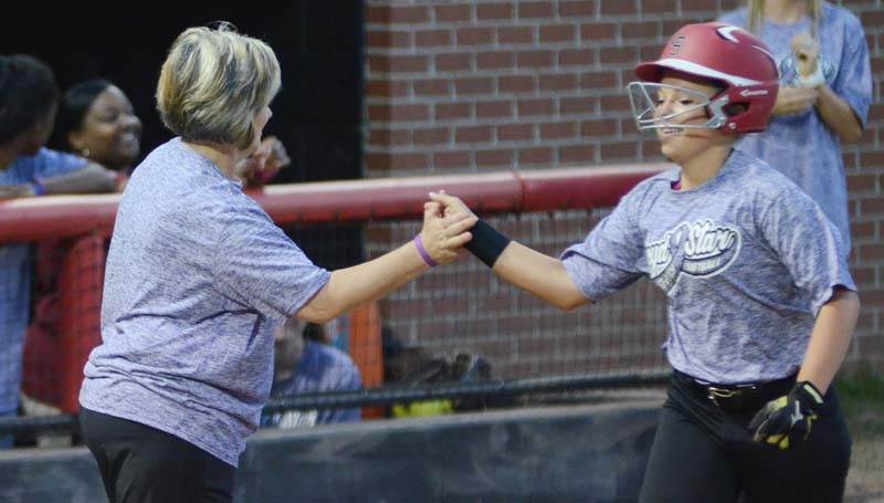 Daily Leader / Marty Albright / Loyd Star's Megan Norton (right) is congratulated along the third base by her coach Jan Delaughter after hitting a three-run homerun in the second inning against Bogue Chitto.