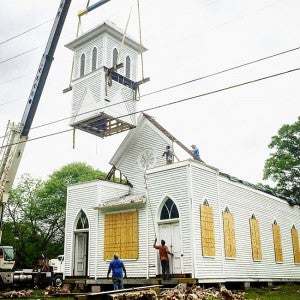Photo by Aaron Paden / Workers moved the old Bogue Chitto Methodist Church on Lee Street to the location of the former Dixie Springs Cafe this week.
