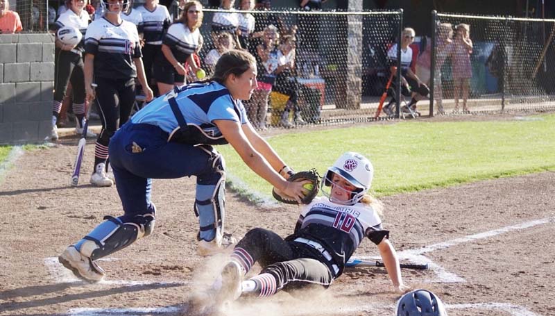 Daily Leader / Jana Harp / Lawrence County's Julianna Johnson slides into home safely under the tag of North Pike catcher Madison Bates.