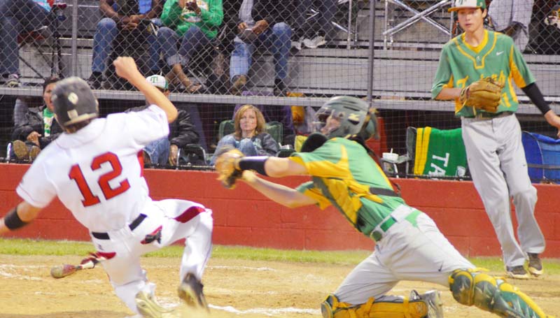 Daily Leader / Chris King / Loyd Star's Konner Allen slides into home plate safely as Taylorville catcher Kenner Todd reaches to make a play at Smith Field.