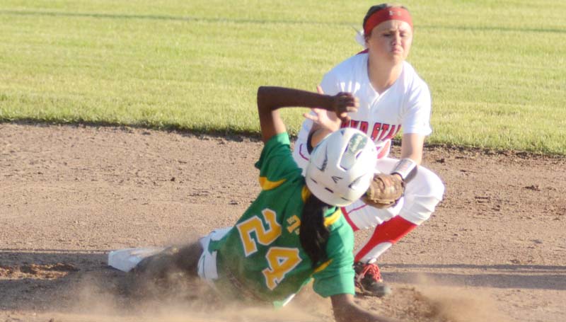 Daily Leader / Marty Albright / Taylorsville's Miracle Crosby (24) slides under the tag of Loyd Star shortstop Abigail Thornton at second base.