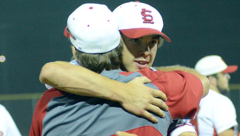 Daily Leader / Marty Albright / Loyd Star head baseball coach Jared Britt and junior Parker Flowers hug after clinching the victory Friday night at Smith Field.