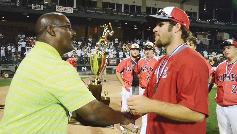 Daily Leader / Loyd Star coach Jared Britt accepts the Class 2A state runner-up tro- phy from MHSAA Director Lonnie Tillman Saturday.