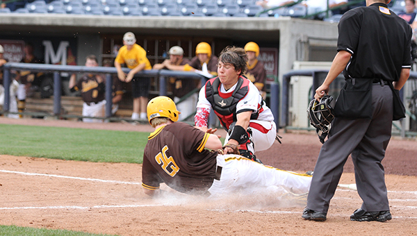 Daily Leader / Amy Rhoads / Loyd Star catcher Tucker Watts tags out East Union's Ty McDonald (25) sliding into home plate Tuesday in game one of the Class 2A State Championship at Trustmark Park.
