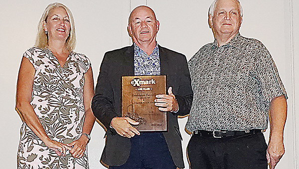 Photo submitted / Mr. and Mrs. Tommy Ready with Brookhaven Rent-All recently won a trip to Hawaii for being one of the top Exmark dealers in a six-state region. R.W. Distributors, Inc., awarded this trip for outstanding sales of Exmark mowers. Robert Whitehead (right), president of R.W. Distributors, Inc., and Judy Altmaier (left), president of Exmark Manufacturing, presented Tommy Ready (middle) with the plaque for the award.
