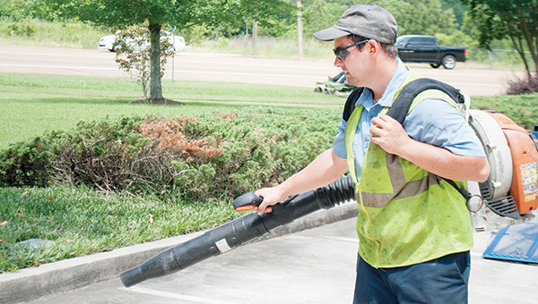 Photo by Aaron Paden / Foreman Westley Forsyth with U.S. Lawns of McComb work to maintain the lawn at Brookhaven Dental Center Friday.
