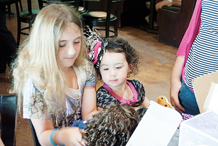 Photo by Aaron Paden/Arabella Jackson plays with Kabella Dubose and Dubose’s new doll on June 2 at Broma’s in Brookhaven.