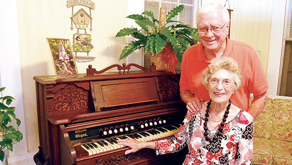 Photo by Donna Campbell/Tom Moak likes to sing hymns while his wife, Willa Moak, plays the antique Parlor Queen organ in their sunroom. The organ, built in the late 1800s, once belonged to Willa Moak’s aunt, Nannie Montgomery.