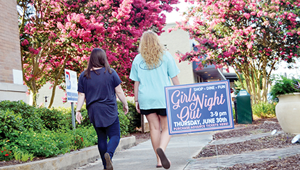 Photo by Donna Campbell/Walkers downtown pass a sign for Girls Night Out in front of the Brookhaven-Lincoln County Chamber of Commerce Wednesday. The sixth annual event, sponsored by the Chamber, is today from 3-9 p.m. at 31 retailers and eateries throughout the city. Tickets are $25 and are available at the Chamber until 6 p.m.