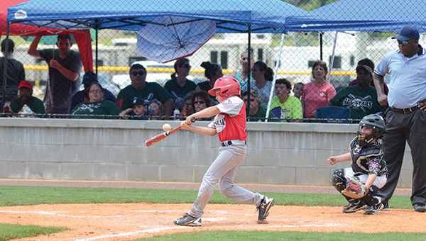 Photo by Anthony McDougle/ American All-Star catcher Bram Wolfe swings and makes contact during his team's first matchup against the Natchez All-Stars. The Lincoln Americans defeated Natchez in their second meeting to avenge a 15-14 loss and be crowned sub-district champions.
