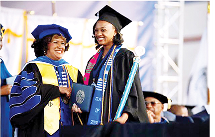 President Carolyn Meyers (left) gives Orionna Brumfield her diploma during commencement exercises at Jackson State University in April. First lady Michelle Obama spoke at that event.