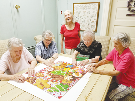 Photo By Donna Campbell/Several retirees often gather on the second floor of The Inez to put together jigsaw puzzles and play bridge. Finishing a puzzle Wednesday are Marian Vivian Morgan (left), Sallie Williford, Betty Jo Smith Barham, Violet Palmer and Marian McMillian.