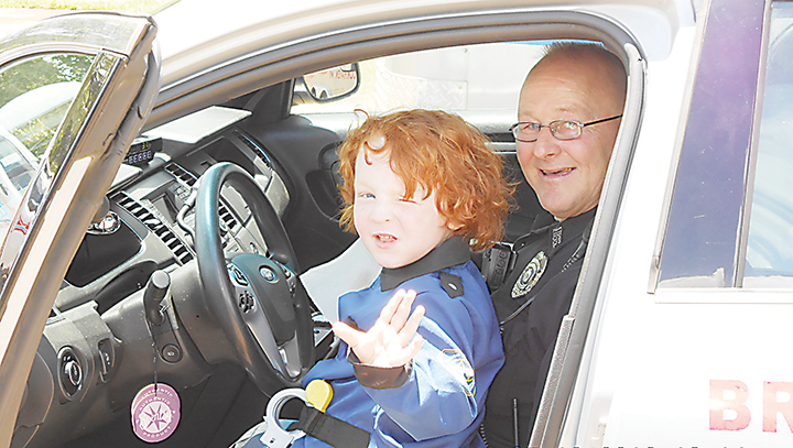 Photos submitted/Brookhaven Police officer Kevin Thompson lets Caden Hobkirk “drive” his squad car during the boy’s recent visit to the station.