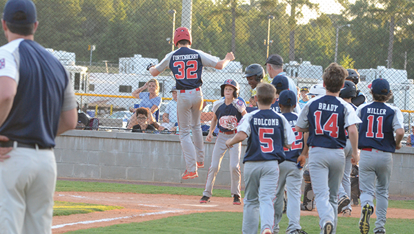 Photo by Anthony McDougle/ Tyler Fortenberry leaps onto home plate after hitting a solo home run in the third inning.