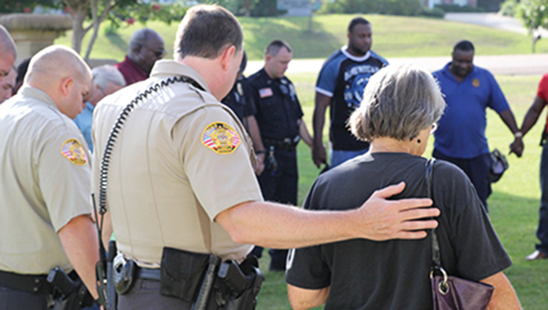 Photos by Amy Rhoads/About 30 law enforcement officers from Brookhaven Police Department and the Lincoln County Sheriff’s Office met this morning at the flagpole in front of the police department to pray for the five officers in Dallas who were killed Thursday night by snipers during a demonstration organized to protest this week’s police-involved shootings in Minnesota and Baton Rouge. Police Chief Bobby Bell said officers and deputies also prayed for protection for local departments and for unity in the community. A story about the ambush in on page 3. See more photos from the prayer service at www.dailyleader.com.