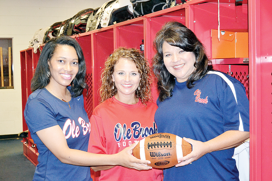 Photo by Donna Campbell/Coaches’ wives Shonique McLaurin (left), Tiffany Bass and April Clopton get ready for the “Lipstick and Laces” ladies-only clinic hosted by Brookhaven High School Saturday beginning at 5:30 p.m. at King’s Daughters Medical Center Performance Center. Brookhaven Academy will also host a similar clinic in the cafeteria Monday beginning at 7:30 p.m.
