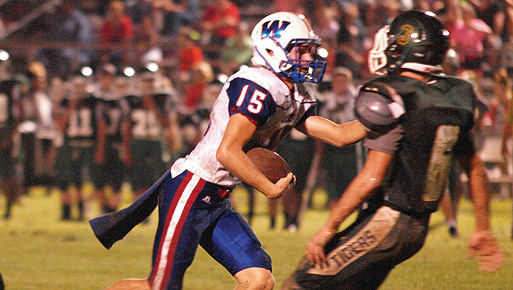Photo by Tracy Fischer/ Wesson quarterback Slay Acy carries the ball upfield as a McLaurin defender moves in to attempt to make a tackle. Wesson defeated McLaurin 14-12 in Thursday night's away game.
